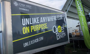 Branded Iowa West Foundation Showmobile trailer with large “Unlike Anywhere Else. On Purpose.” message.